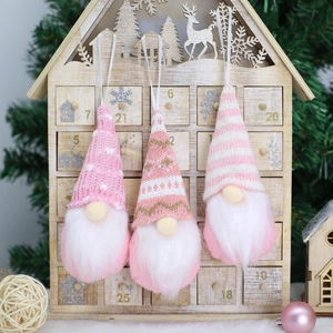 Three pink Christmas gnome hanging ornaments with knit hats for festive holiday tree decor