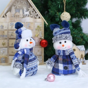 Blue knit Christmas snowman plush figures with plaid hats on a festive background