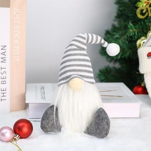 Christmas gnome doll with grey striped hat and white beard on a festive holiday background