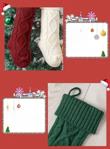 Detail of knitted Christmas stockings in wine red, ivory, and green with hanging loops