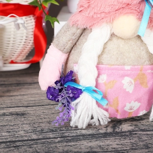Pink and grey Valentine's Day gnome plush with long braids and purple flowers
