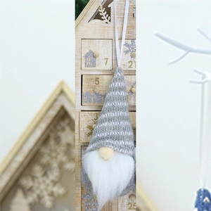 Detail of a Christmas gnome ornament with striped knit hat and white faux fur beard