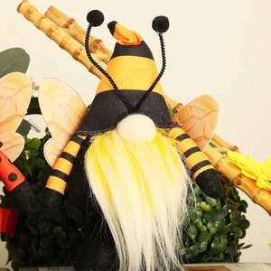 Detailed view of bee-themed gnome figurine with yellow-black stripes and plush white beard