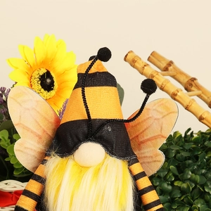 Close-up of a bee-themed gnome doll with yellow plush beard and translucent wings