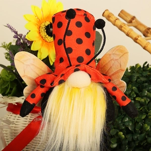 Close-up of a ladybug-themed gnome with polka dot hat and bright yellow faux fur beard