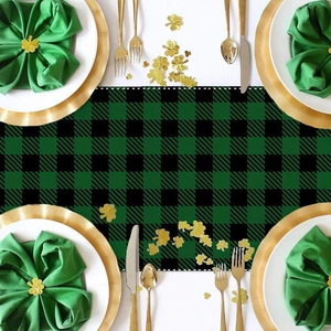 Green and black buffalo plaid St. Patrick's Day table runner with clover decor on table