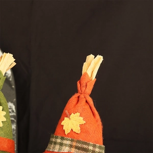 Detailed macro view of orange felt dwarf hat with maple leaf and plaid ribbon for autumn