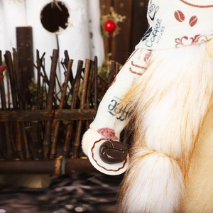 Detailed macro view of Coffee House gnome plush holding a plate with realistic coffee beans