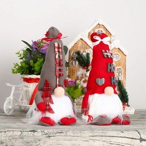 Detail of Christmas gnomes with LED lights, showing grey and red festive fabric textures