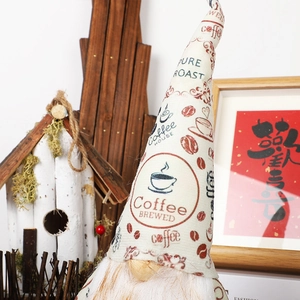 Close-up of coffee gnome detail showing pure roast text and knitted fabric texture