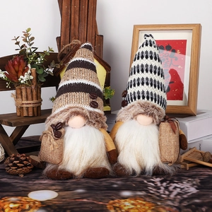 Set of two festive Christmas coffee gnomes with knitted hats and warm winter decorations