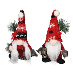 Detail view of plush Christmas gnomes with knit hats, candy canes and rustic lanterns