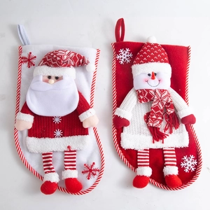 Close-up of 3D plush Santa and Snowman Christmas stockings with snowflake embroidery