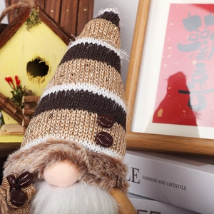 Close-up of coffee gnome with striped knit hat and miniature burlap coffee bean bag
