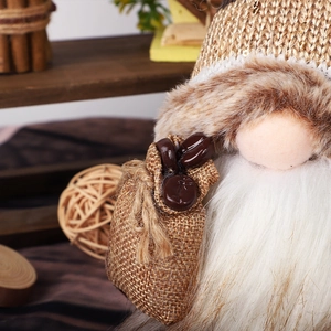 Detailed close-up of coffee bean accessories in a burlap sack on a knit gnome doll