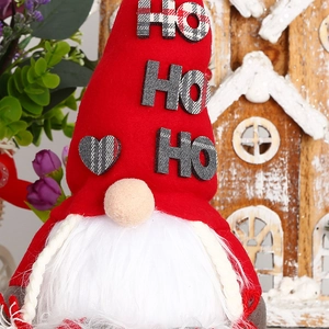 Detailed close-up of a Christmas gnome doll with a red hat and HO HO HO decorative letters