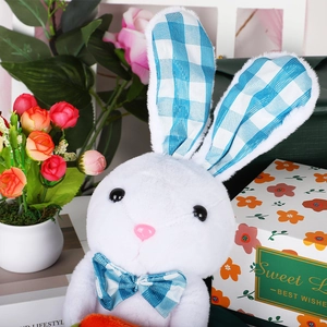 Illuminated white plush bunny with blue plaid details holding a carrot for Easter decor