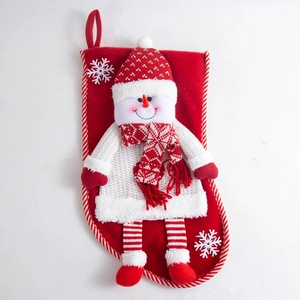 Detail of 3D snowman figurine with knitted sweater on a red Christmas stocking with loop