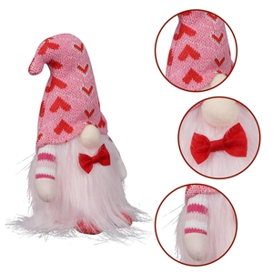 Detail shots of pink knit gnome hat with heart pattern and plush beard textures