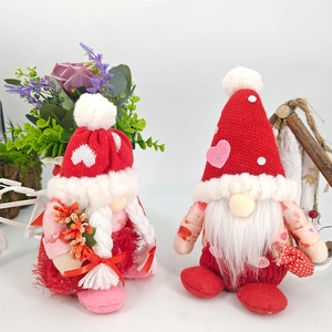 Red and pink Valentine's Day gnome plush dolls with hearts on a clean white background