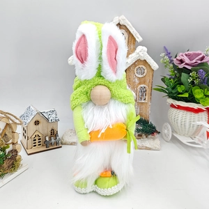 Detail of Easter gnome with bunny ears holding a plush carrot decoration