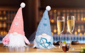 Close-up of Valentine's gnome couple with glowing LED lights on a rustic wooden table