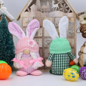 Pink and green Easter rabbit gnomes with carrot and heart details on a festive background