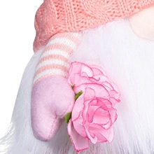 Macro shot of knitted hat and faux roses held by a plush Valentine's Gnome ornament