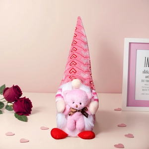Pink Valentine gnome with knitted heart hat holding a plush bear in a romantic setting