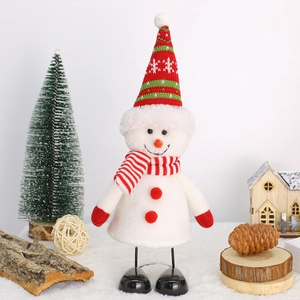 Christmas snowman plush doll ornament with spring legs and festive knit hat on wood
