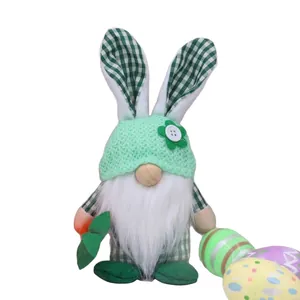 Easter gnome plush doll with rabbit ears holding a decorative egg on white background
