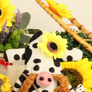 Close-up of a cow pattern gnome with a yellow sunflower and braided brown beard