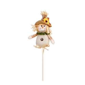 Detail view of harvest scarecrow with sunflower hat and burlap texture on wooden stick