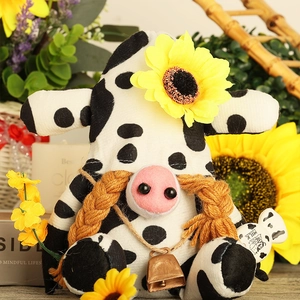 Cow pattern gnome plush with sunflower and milk prop in rustic garden decoration
