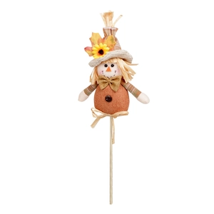 Detail view of harvest scarecrow garden stake with orange fabric and sunflower accent
