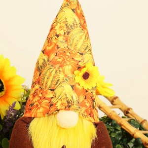 Detailed view of autumn gnome with pumpkin patterns and soft fabric textures for harvest décor