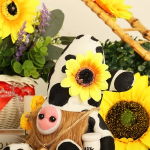 Sunflower cow gnome holding a milk bucket with rustic farmhouse floral background