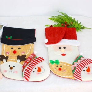 Christmas stockings with Santa and Gingerbread Man hanging decor on a white rug