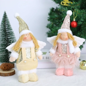 Christmas plush angel dolls with gold and pink sequins in a festive holiday scene