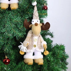 Close-up of reindeer Christmas ornament with mini skis hanging on a tree branch