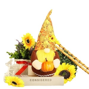 Plush Thanksgiving gnome holding a pumpkin for festive autumn harvest home decoration