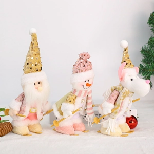 Pink and white Christmas plush skiing figurines with gold sequins and wooden base