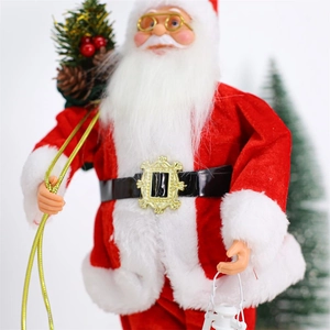 Detail of Santa Claus doll in red velvet suit holding a vintage lantern and pine needles