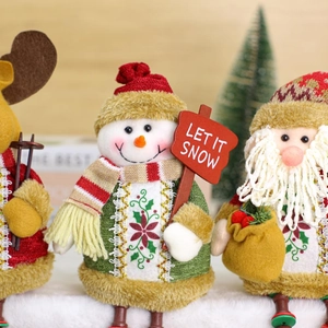 Plush Christmas decorations set with Santa, Snowman and Reindeer on wooden background