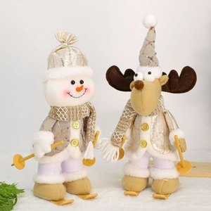 Christmas snowman and reindeer figurines in gold sequins with skis and poles