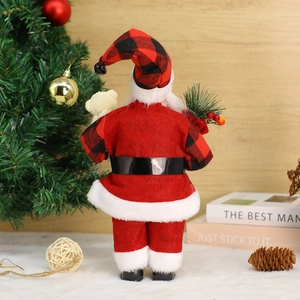 Standing Santa Claus doll in red felt outfit holding a small bear and pine needles