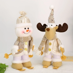Detail of Christmas snowman and reindeer plush figurines wearing gold sequin coats on skis