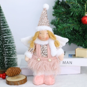 Detailed close-up of Christmas angel plush doll with sequins and feather trim