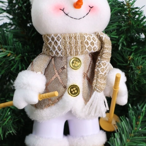 Detail of Christmas snowman plush with gold sequins, knit scarf and yellow ski poles