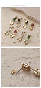 Detailed view of monstera leaf earrings with colorful rectangular zircon in gold finish